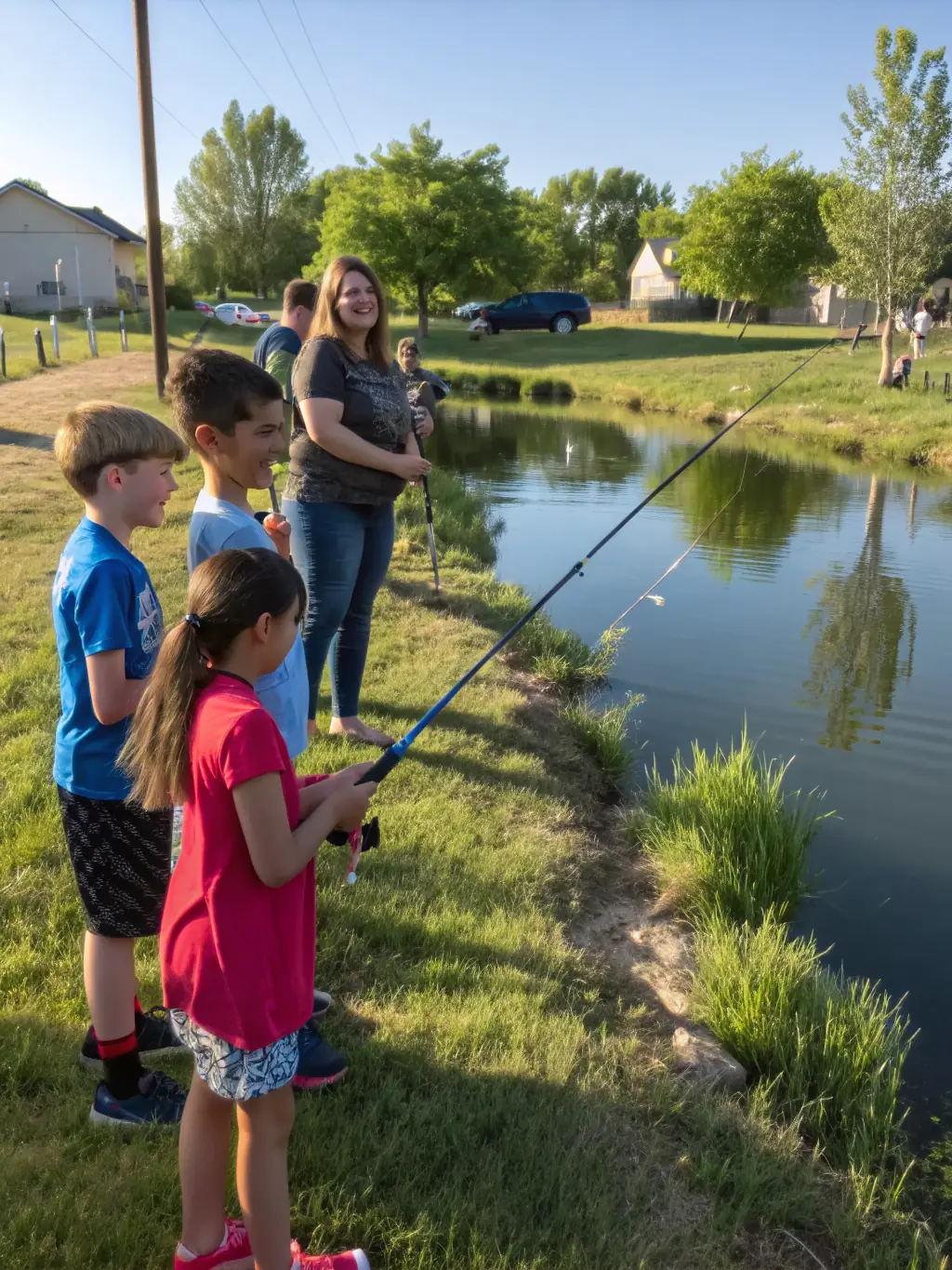 A picture of children learning how to fish during a AAPPMA-organized fishing workshop, with instructors demonstrating proper techniques and safety measures.